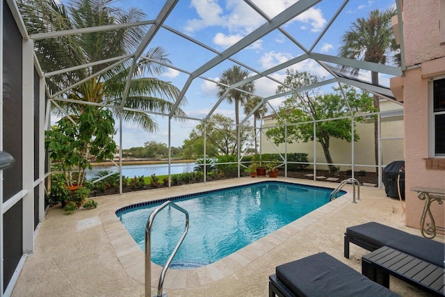 view of swimming pool with a lanai, a water view, and a patio