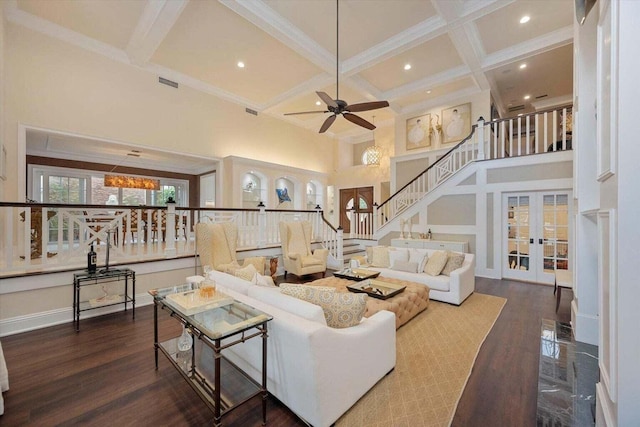 living room featuring french doors, coffered ceiling, a high ceiling, beamed ceiling, and hardwood / wood-style floors