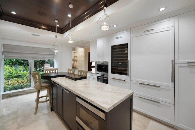 kitchen featuring white cabinetry, wine cooler, hanging light fixtures, light stone countertops, and stainless steel appliances