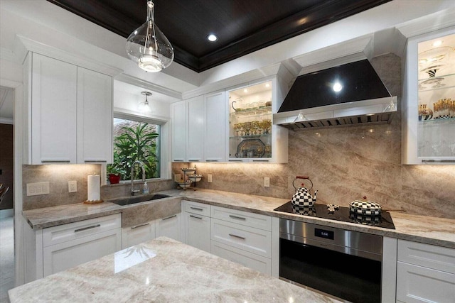 kitchen with black electric cooktop, white cabinetry, sink, and oven