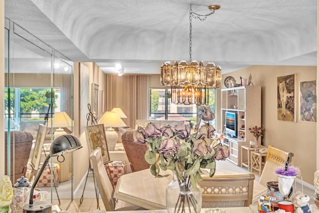 dining space featuring a notable chandelier and a textured ceiling