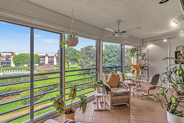 sunroom featuring ceiling fan and a wealth of natural light