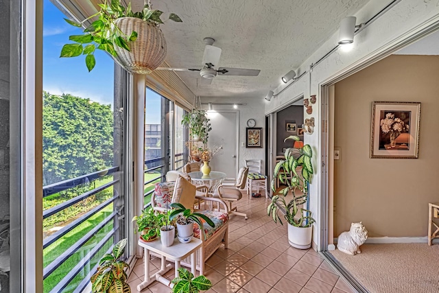 sunroom / solarium featuring ceiling fan