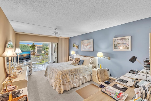 bedroom featuring ceiling fan, carpet flooring, a textured ceiling, and access to exterior