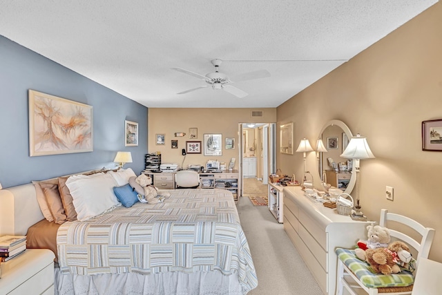 carpeted bedroom featuring a textured ceiling and ceiling fan