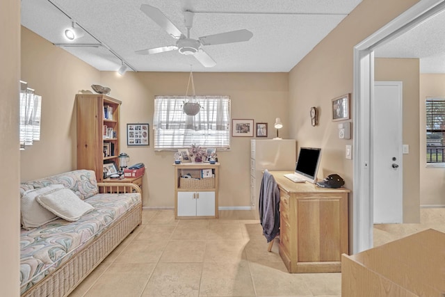 tiled office with ceiling fan, a textured ceiling, and track lighting