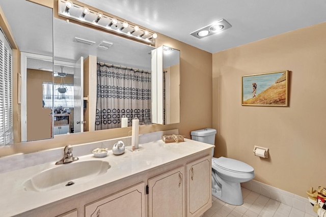 bathroom with vanity, toilet, and tile patterned floors