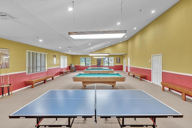 playroom with light carpet, pool table, and a textured ceiling