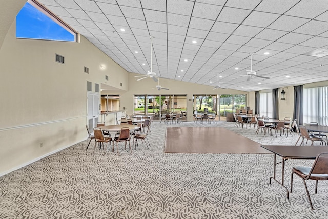 dining room with ceiling fan, light carpet, and high vaulted ceiling