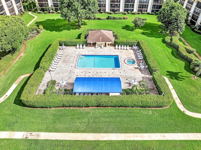 view of pool with a lawn