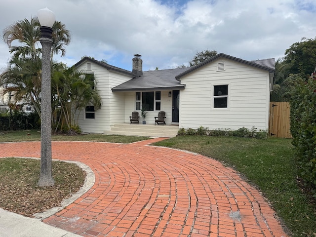 exterior space with a lawn and a porch