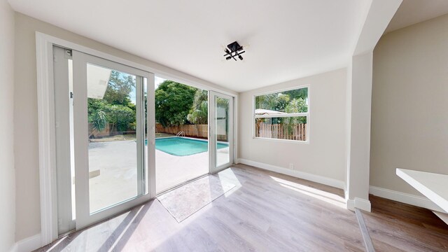 unfurnished room featuring light wood-type flooring and a wealth of natural light