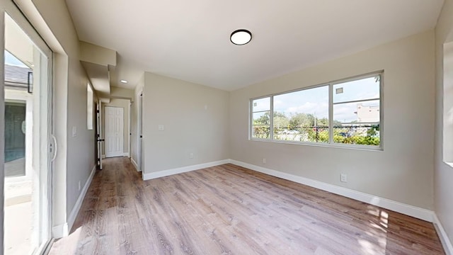 spare room with light hardwood / wood-style flooring