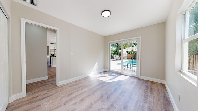 unfurnished room with light hardwood / wood-style floors