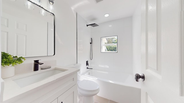 full bathroom featuring vanity, tiled shower / bath combo, toilet, and tile patterned flooring