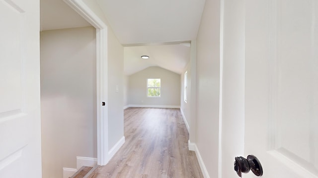 hallway with light hardwood / wood-style floors