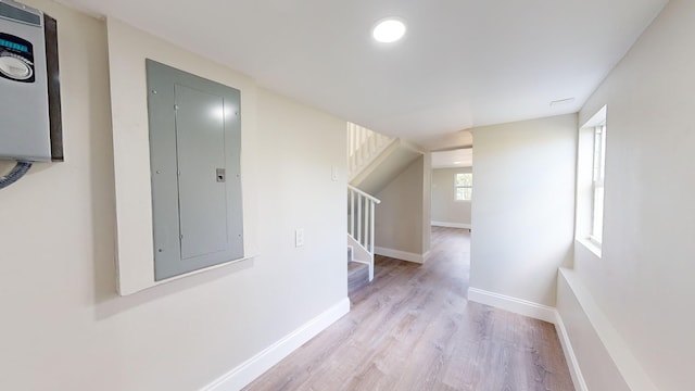 corridor featuring light wood-type flooring and electric panel