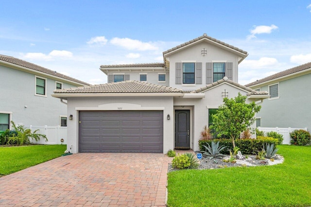 mediterranean / spanish home with a front lawn