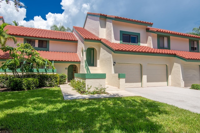 15 Lexington Ln E Unit G, Palm Beach Gardens, FL 33418 - mediterranean / spanish house featuring a garage, a front lawn, and stucco siding