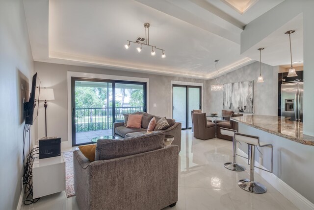 living room featuring a tray ceiling