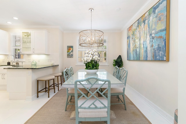 dining room featuring a wealth of natural light, sink, and crown molding