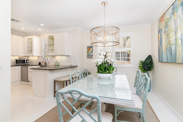 dining area featuring crown molding and a chandelier