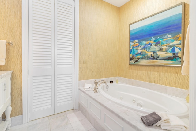 bathroom with a tub to relax in and tile patterned floors