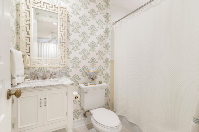 bathroom featuring vanity, toilet, a shower with shower curtain, and tile patterned floors