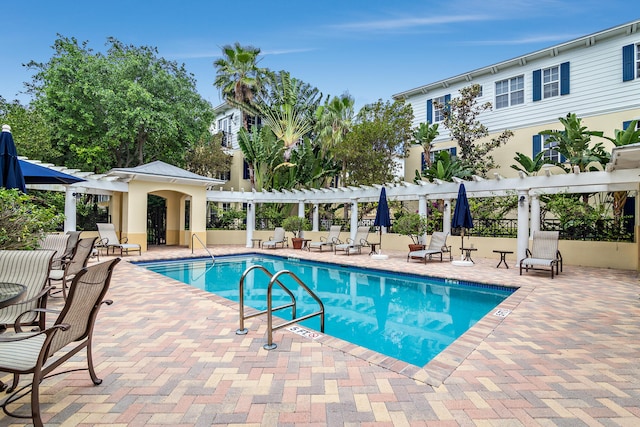 view of pool with a pergola and a patio