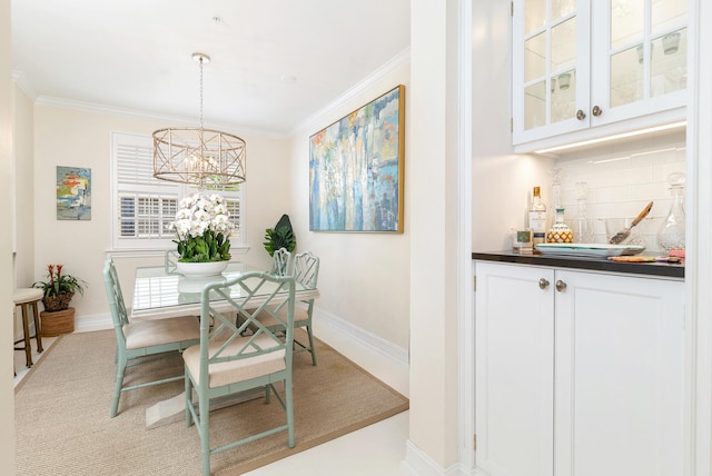 dining area featuring an inviting chandelier, light carpet, and ornamental molding