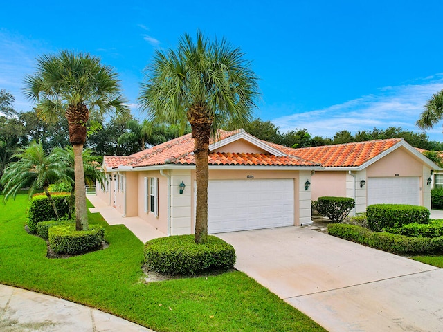 view of front of property with a front yard and a garage