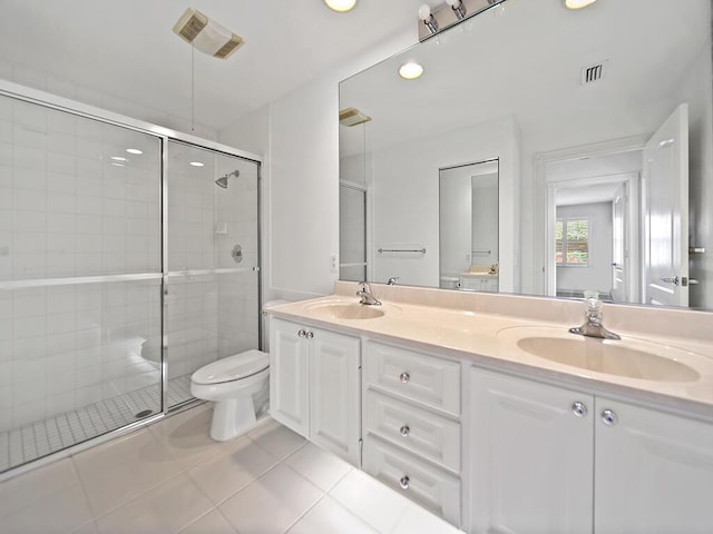 bathroom with tile patterned floors, vanity, toilet, and an enclosed shower