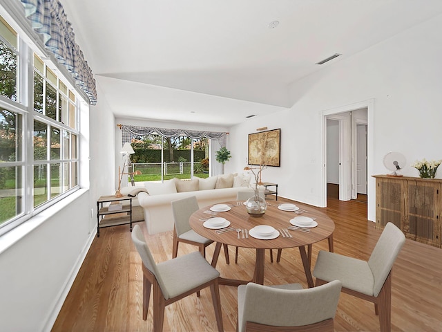 dining area featuring dark hardwood / wood-style floors, a healthy amount of sunlight, and french doors