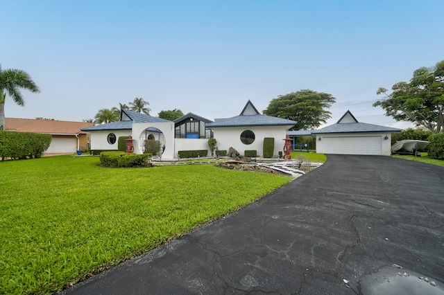 view of front of property with a garage and a front lawn