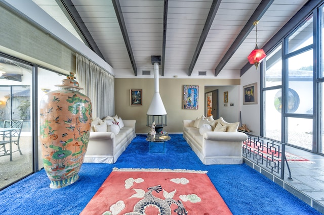 living room featuring vaulted ceiling with beams, dark carpet, and a wealth of natural light