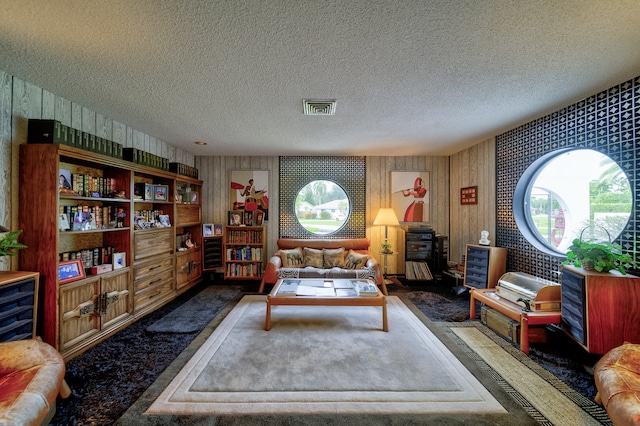 living room with dark colored carpet and a textured ceiling