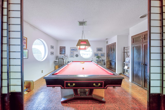 game room featuring a textured ceiling and billiards