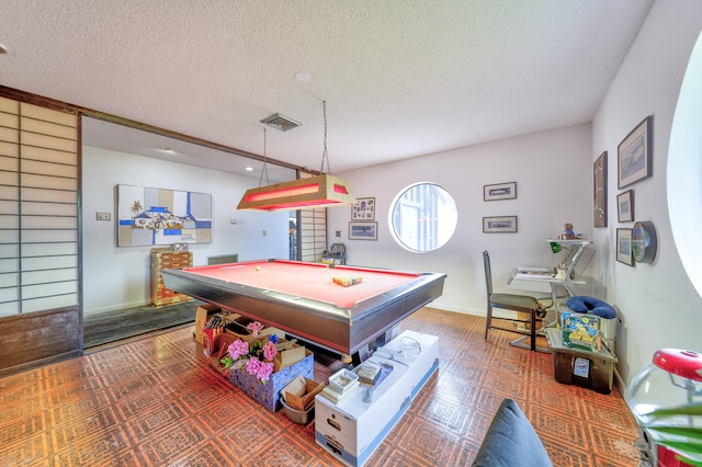 playroom featuring dark tile patterned flooring, a textured ceiling, and billiards