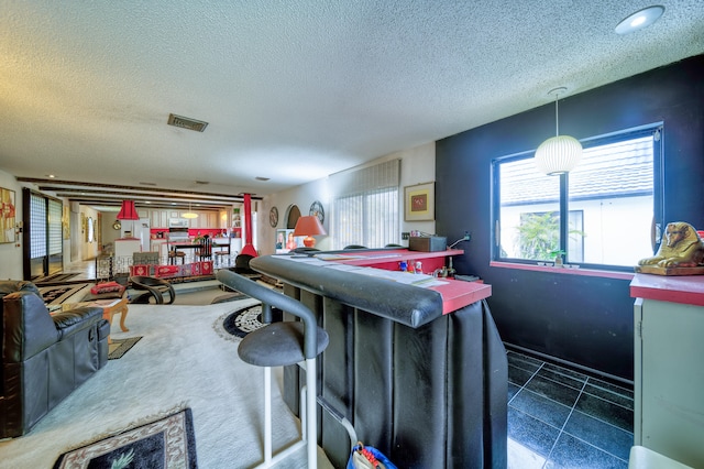 kitchen featuring a textured ceiling and decorative light fixtures