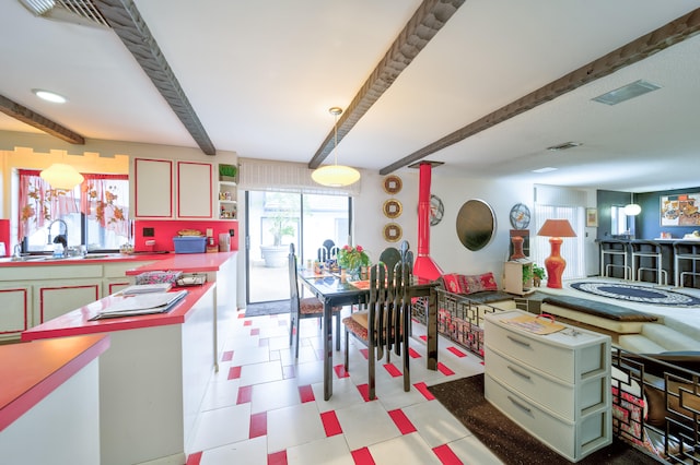 interior space featuring beam ceiling and sink