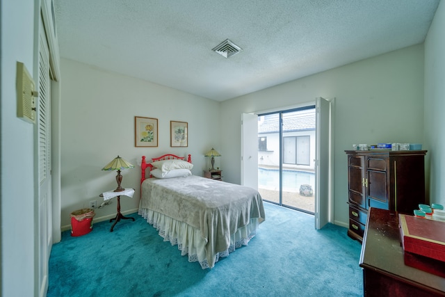 bedroom with access to outside, a textured ceiling, and carpet flooring