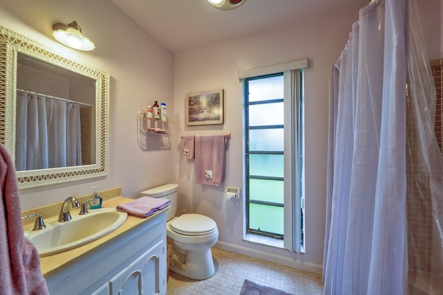 bathroom with a shower with curtain, vanity, tile patterned flooring, and toilet