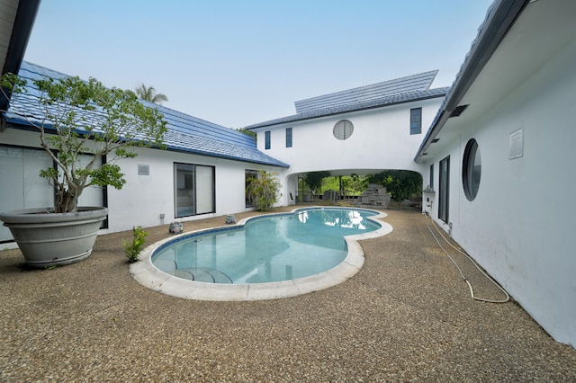 view of swimming pool featuring a patio area