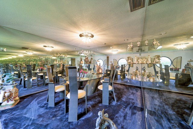 exercise room with a textured ceiling, carpet floors, and bar