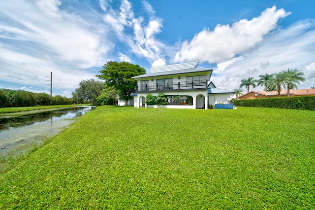 exterior space with a gazebo, a water view, and a front lawn