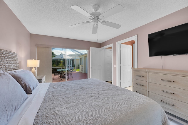 bedroom with ceiling fan, a textured ceiling, and access to exterior