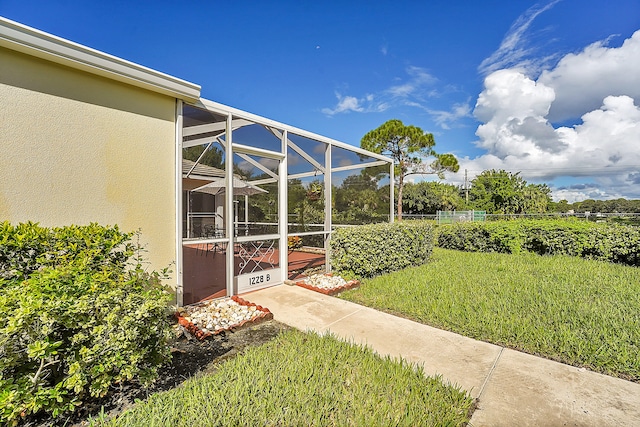 view of yard featuring glass enclosure