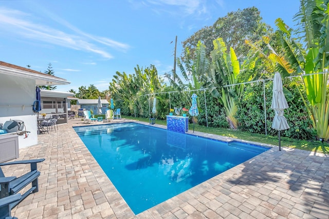 view of swimming pool with a fenced in pool, a patio area, and fence