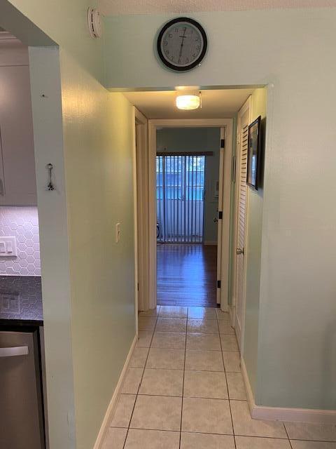 corridor with light tile patterned floors