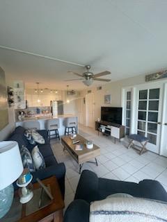 tiled living area featuring ceiling fan